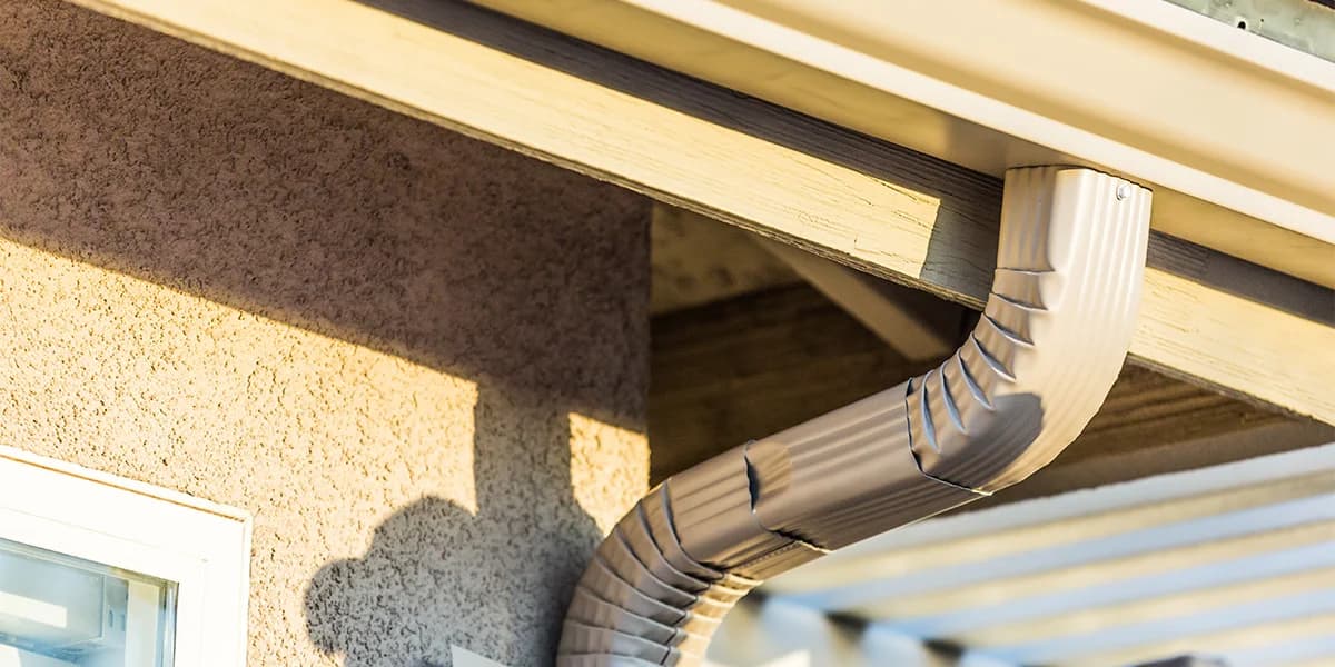 Aluminum eavestrough and downspout detail on a Cochrane Alberta home