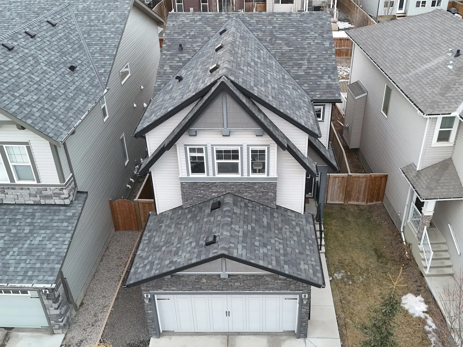 Hail damage roof repair completed by Sure West Roofing in Cochrane Alberta