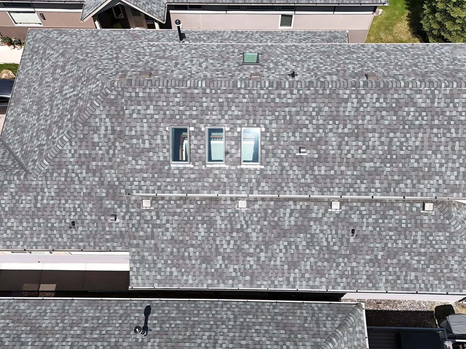 Aerial view of three skylights installed in a row on a Cochrane Alberta home roof